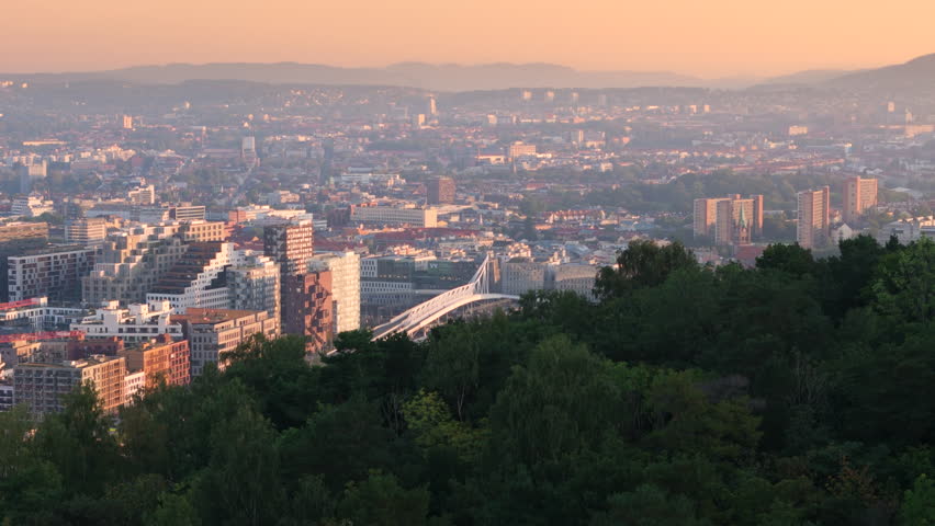 Sunrise glow over Oslo city with view of iconic Nordenga Bridge. Aerial