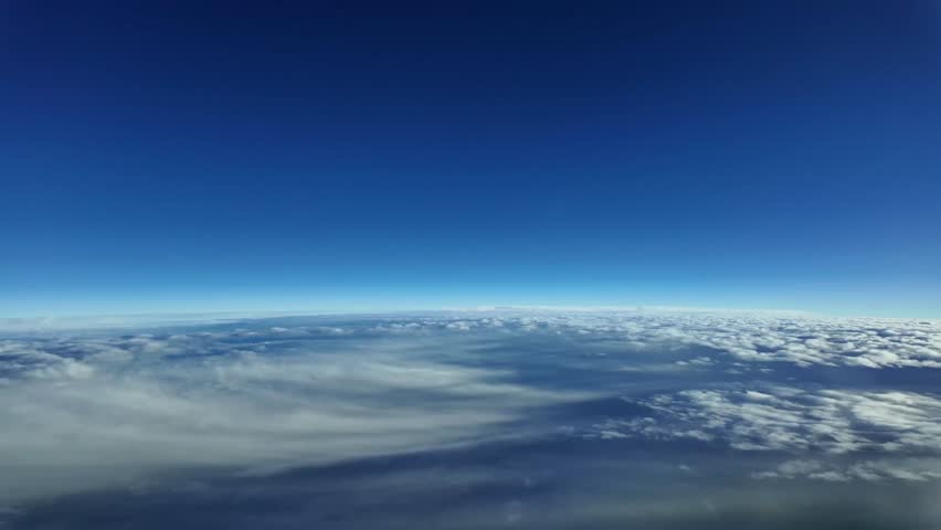 Pilot POV flying at stratosphere level and supersonic speed. Aerial footage taken from fighter cockpit jet flying very high at sunset over layers of stratus clouds. 4K. Hyper lapse.