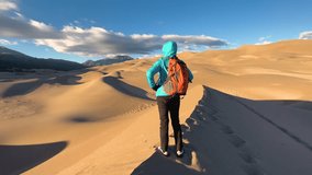 Sunrise backpacking female exploring giant dunes Extreme Wilderness desert Great Sand Dunes National Park travel tourism Colorado - Powered by Shutterstock - Get 15% off with code: PIKWIZARD15