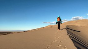 Walking female solo adventure at sunrise in winter exploring Great Sand Dunes National Park Colorado USA travel tourism - Powered by Shutterstock - Get 15% off with code: PIKWIZARD15