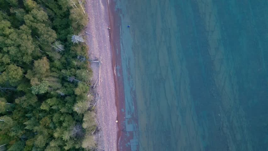 Lake Superior Shoreline from the Upper Peninsula of Michigan, Aerial View Descending Into A View of the Shore and Lake at Sunset