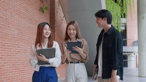 Attractive young Asian businessman and businesswoman talking as team discuss project outside office.Group of Asian employee walking outdoors in city. Corporate of modern colleagues concept - Powered by Shutterstock - Get 15% off with code: PIKWIZARD15