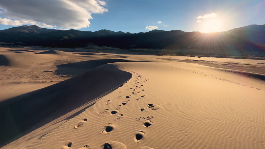 Motion tracking female exploring sunrise remote Great Sand Dunes National Park walking vacation Colorado USA travel tourism