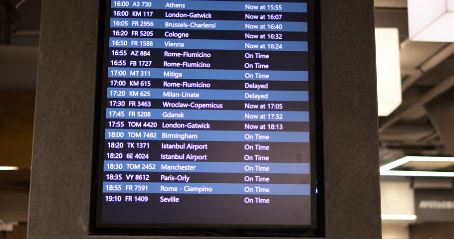 Airport departures information on digital display for passengers on concrete wall. Info board screen with arrivals data for customers comfort in hall