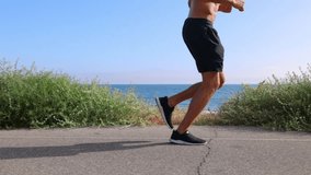 Athletic man jogging at the beach in Southern California. Slow Motion. - Powered by Shutterstock - Get 15% off with code: PIKWIZARD15
