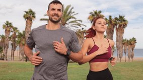 Man and woman exercising outdoors, running along a palm lined path, taking a break after an intense workout, showcasing fitness, endurance, and healthy lifestyle through outdoor sports activities - Powered by Shutterstock - Get 15% off with code: PIKWIZARD15