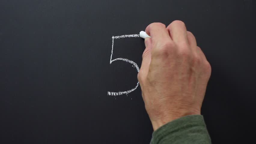 Hand writes the number 5 with white chalk on a black board