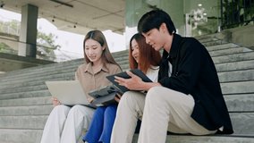 Asian Creative agency business people talking and sitting on steps at office tower,discussion and relax.Asian men and women as journalist with conversation,opinion and listening in workplace stairs - Powered by Shutterstock - Get 15% off with code: PIKWIZARD15