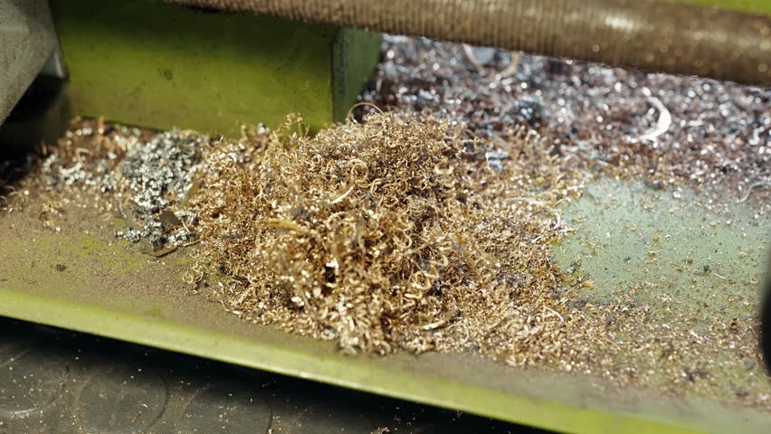 Golden and silver chips in a jewelry workshop after processing the gold