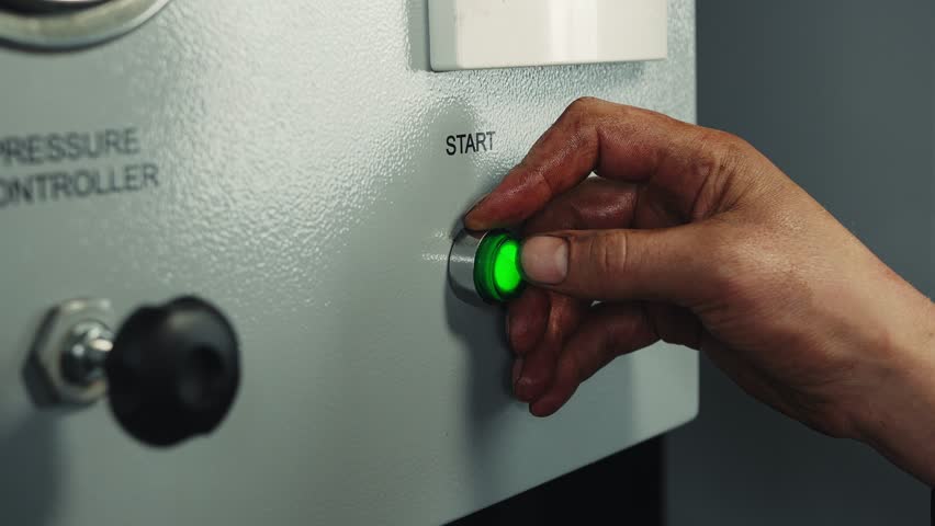 Green button power on with Start sign, finger pushing button and start engine electrical equipment in industrial factory, wwitch on or turn on the electricity