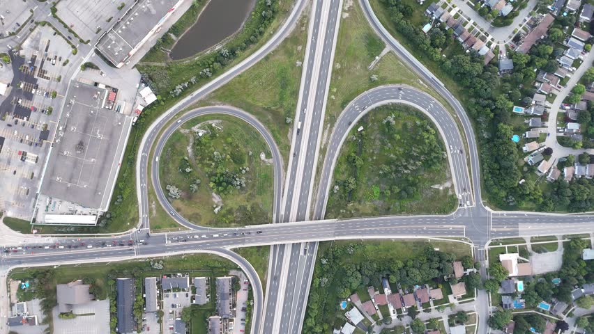 An aerial footage of the Highway 8 and the nearby residential buildings at sunset in Ontario Province, Canada