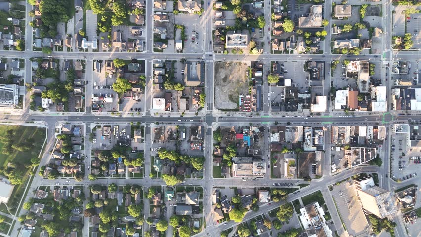 A top down aerial footage of intersection roads in a residential district in Waterloo city on a sunny day, Ontario, Canada