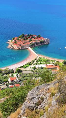 Enjoy stunning aerial views of Sveti Stefan island in Montenegro, surrounded by clear waters and vibrant landscapes ideal for exploration and outdoor adventures yearround