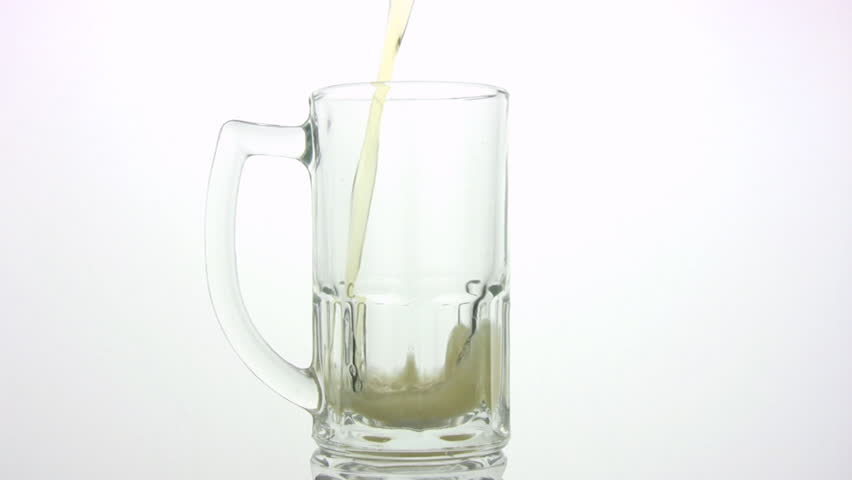 The beer by a jet is poured in a mug, the bubbles rise to a surface. A white