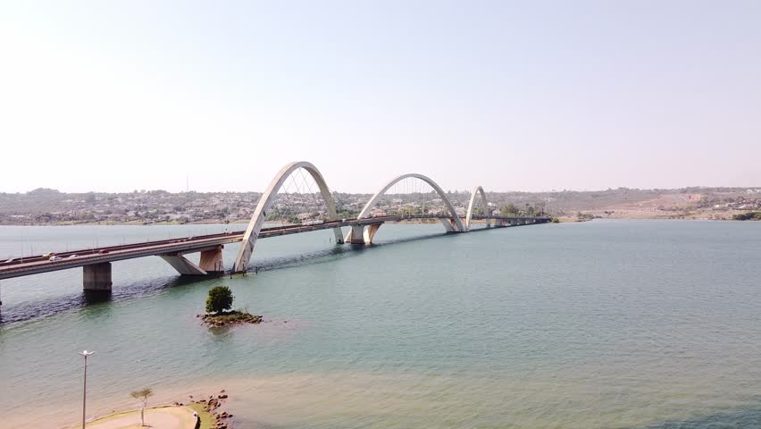 A drone footage of Juscelino Kubitschek Bridge over Lake Paranoa on a sunny day in Brasilia, Brazil