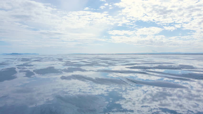 Cinematic flyover of reflective Bonneville Salt Flat in Utah, USA