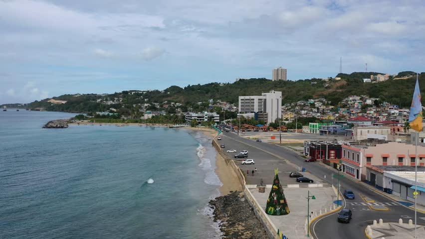A drone footage of Rompeolas Beach (Playa Rompe Olas) and Bandera de Puerto Rico view in Aguadilla, Puerto Rico