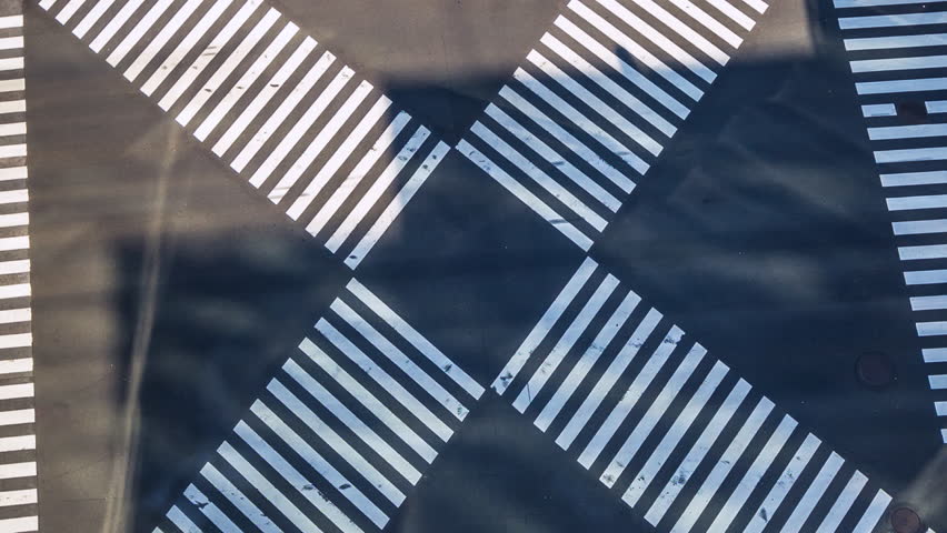 Time lapse top view of pedestrian crosswalk at intersection in Tokyo, Japan, Asia.