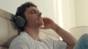 Caucasian man male guy listening music headphones closed eyes enjoyment relaxing sing song gadget technology playlist radio bedroom home satisfaction earphones audio device wireless connection sound - Powered by Shutterstock - Get 15% off with code: PIKWIZARD15