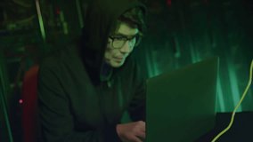 Animation of data processing and world map over asian male hacker using laptop. Technology and digital interface concept digitally generated video. - Powered by Shutterstock - Get 15% off with code: PIKWIZARD15