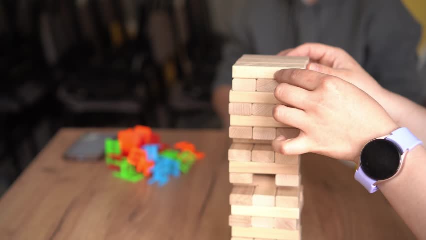 Friends gather for a game night, playing a challenging board game that requires skill and strategy. The playful competition brings laughter and unforgettable moments.