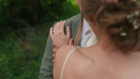 Slow Motion Over Shoulder Shot Brides Hand with Diamond Ring on Groom's Shoulder - Powered by Shutterstock - Get 15% off with code: PIKWIZARD15