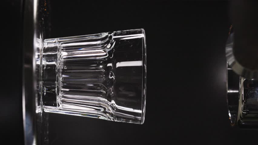 Coffee machine filling glass with black espresso