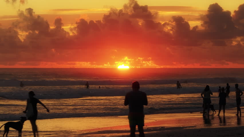 Experience the serene beauty of Playa Santa Teresa in Puntarenas, Costa Rica, where a breathtaking sunset casts golden hues over the beach, creating a tranquil atmosphere perfect for relaxation