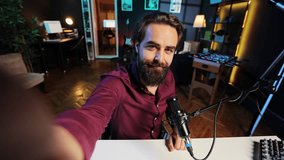 Upbeat content creator hosting online show in rgb lights studio, shooting vlog using selfie camera. POV of cheerful vlogger talking during streaming service broadcast filmed with mobile phone - Powered by Shutterstock - Get 15% off with code: PIKWIZARD15