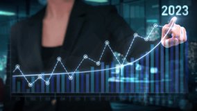 Businesswoman interacts with a glowing digital graph showing an upward trend, symbolizing growth and positive financial performance. The year 2023 is highlighted, emphasizing future business success - Powered by Shutterstock - Get 15% off with code: PIKWIZARD15