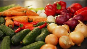 Hot pepper falls on the colorful vegetables on the table. One red pepper gets stuck in the cucumbers and remains in a vertical position. High quality FullHD footage - Powered by Shutterstock - Get 15% off with code: PIKWIZARD15