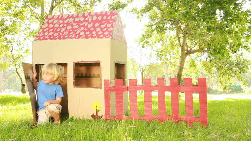 Video of happy little children sitting in playhouse. 