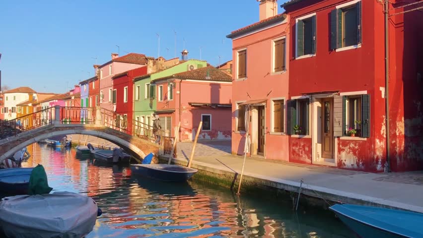bridge over canal with multicolored houses of Burano island, Venice, Italy