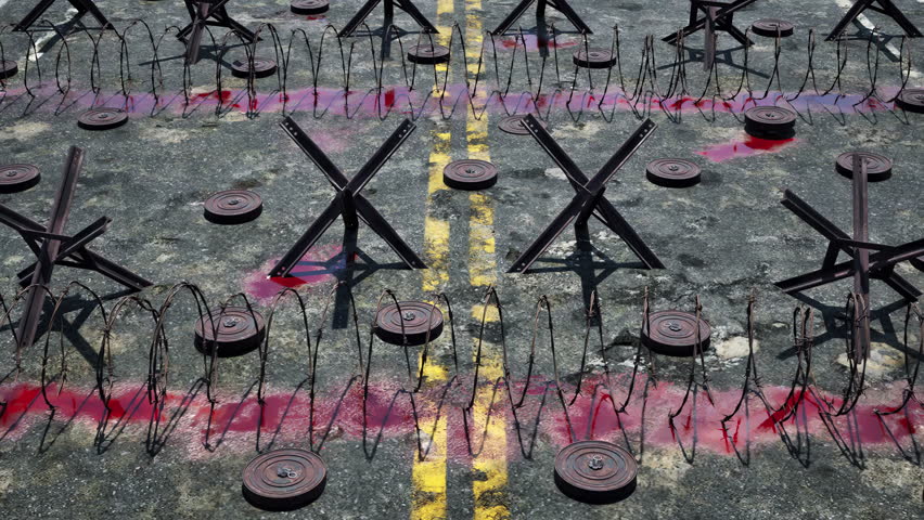 A war-torn bloodstained road covered in tank traps, mines, and barbed wire obstacles.