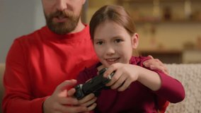 Caucasian family playing video game addict child kid little girl play online console with dad adult man father support parental control daughter play joystick gaming addiction gamer on couch at home - Powered by Shutterstock - Get 15% off with code: PIKWIZARD15