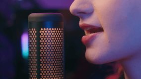 Close up unrecognizable girl woman female mouth talk radio host streamer teen gamer player blogger influencer vlogger record mic microphone online stream esport tournament cyber sport night neon light - Powered by Shutterstock - Get 15% off with code: PIKWIZARD15
