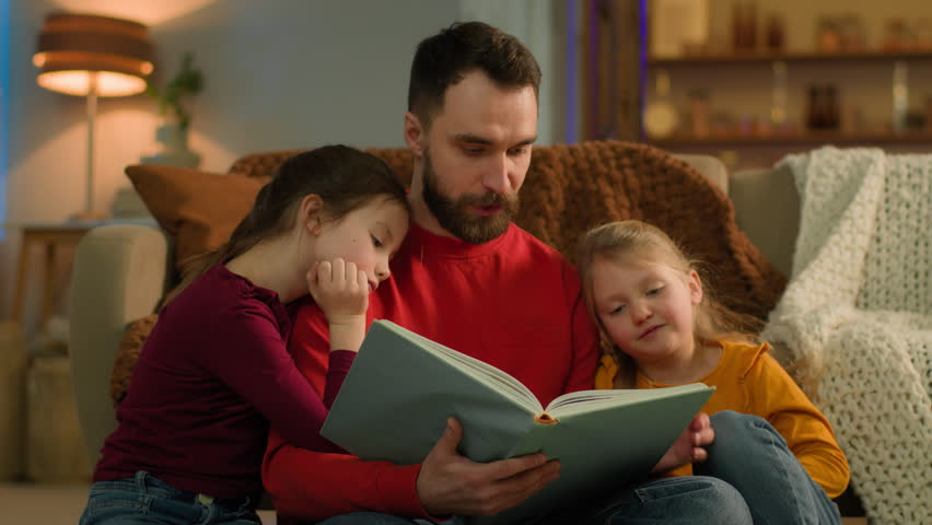 Evening weekend home Caucasian family parent father read book little kids girls children night sleep bedtime dad and daughters reading fairy tale story learn knowledge elementary education childcare