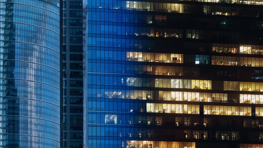 Day to night time-lapse timeslice effect blinking office windows lights, high-rise glass skyscrapers business buildings in city downtown, work non-stop, turn on and off, endless work without breaks