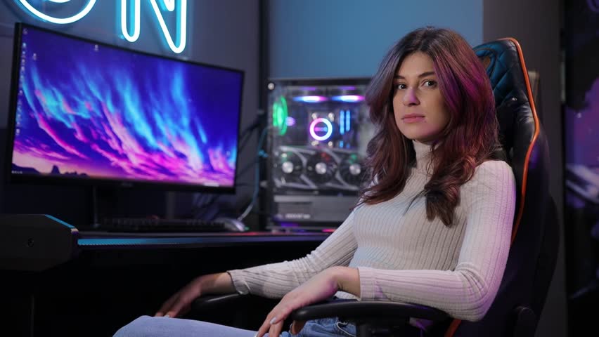 A woman deeply engaged in gaming while seated in a chair