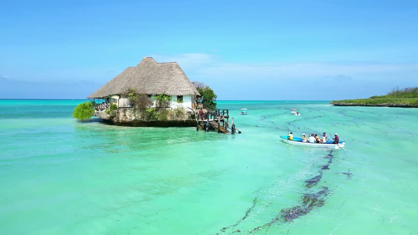 Drone Aerial view Zanzibar 4k. Restaurant on rock in ocean. Tropical island vacation, Africa tourism destination. 