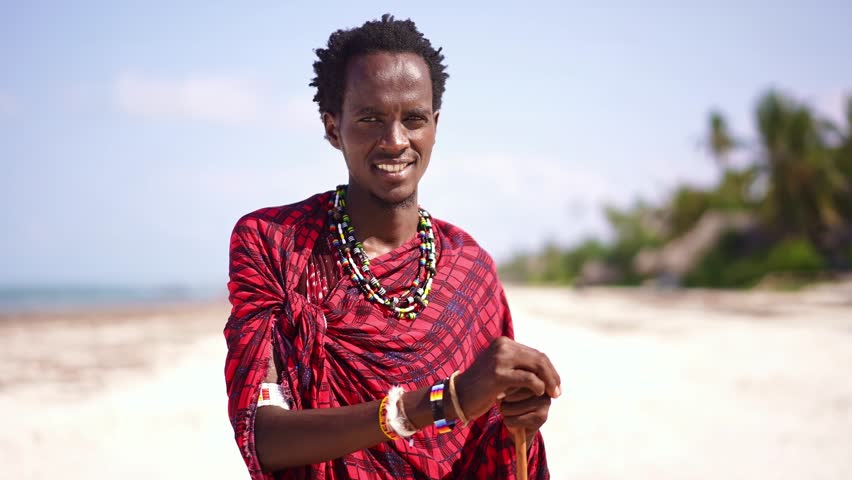 Africa Maasai man portrait, traditional outfit on beach. African warrior tribesman in Zanzibar tropical island. tourism destination in Tanzania. 