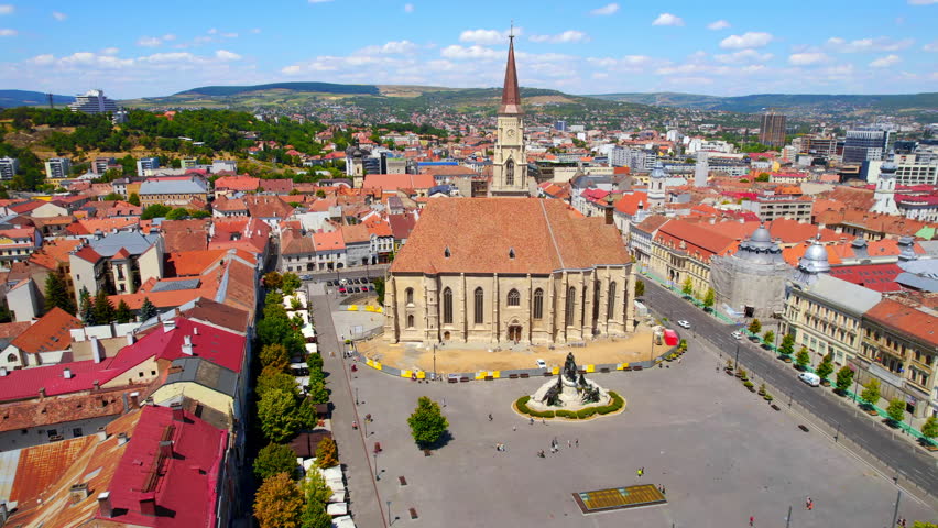 Aerial drone view of Saint Michael Church in Cluj, Romania. Cityscape, central square, old buildings, cars