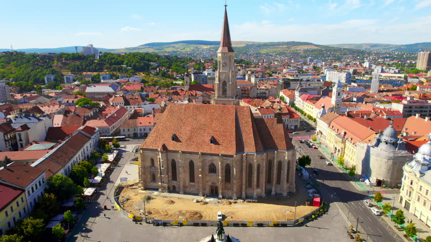 Aerial drone view of Saint Michael Church in Cluj, Romania. Cityscape, central square, old buildings, cars