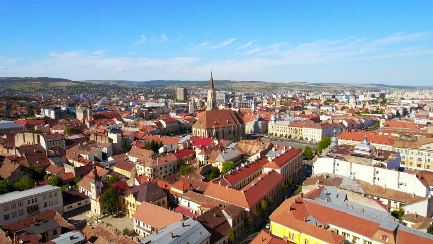 Aerial drone view of Saint Michael Church in Cluj, Romania. Cityscape, central square, old buildings, cars
