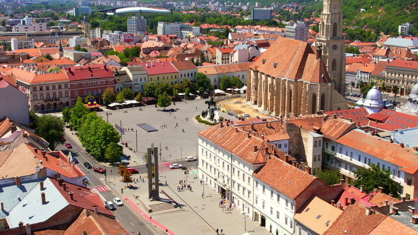 Aerial drone view of Saint Michael Church in Cluj, Romania. Cityscape, central square, old buildings, cars
