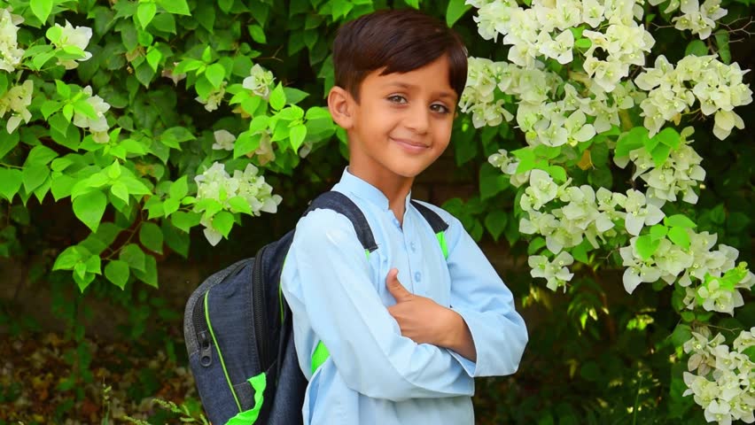 4k Footage of 5 Year old boy student from Punjab Pakistan. Pakistani baby boy student  wearing school bag and ready to go to school. First day in city. Education Concept. Education in Pakistani cites.