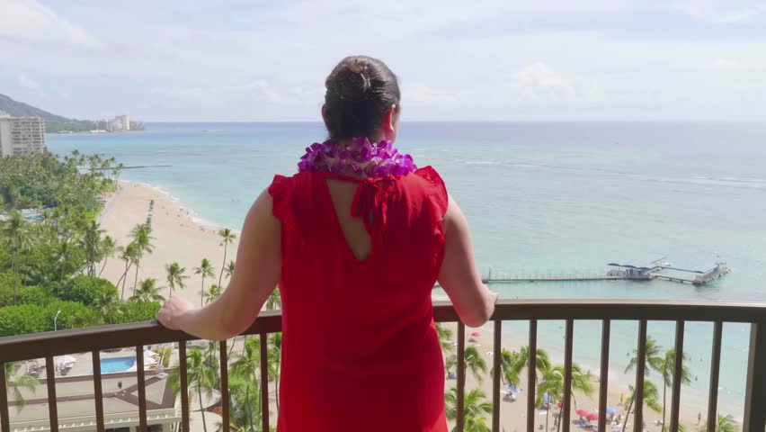 Woman admires the beautiful view of Waikiki Beach in Honolulu in Hawaii from above in 4k slow motion 60fps