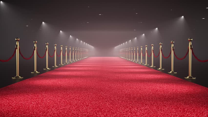 Camera is moving trough the spotlit red carpet decorated with velvet ropes