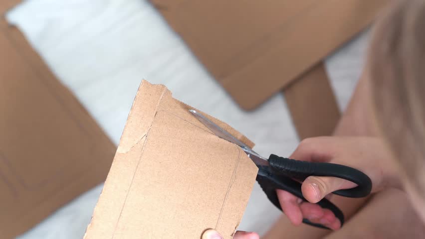 Stationery scissors in the hands of a child in close-up. Children