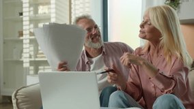 Happy senior elderly Caucasian couple retired married woman female man male talking family papers documents purchase finance grandparents success thumbs up cheering use laptop computer e-banking home - Powered by Shutterstock - Get 15% off with code: PIKWIZARD15